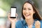 Excited woman showing a blank phone screen