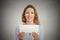 Excited woman showing empty blank paper card sign with copy space