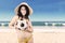 Excited woman in swimsuit holding soccer ball 1