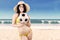 Excited woman in swimsuit holding soccer ball