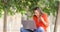 Excited woman using a laptop on a bench