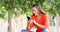 Excited woman using a phone in a park