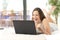 Excited woman winning online watching laptop