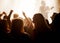 Excited women, friends and fans at music festival, lights and crowd in silhouette at live band performance on stage