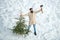 Excited woodsman with Christmas tree. Winter portrait of lumber in snow Garden cutting Christmas tree. Happy winter time