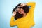 Excited young african female in sunglasses on blue background