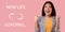 Excited young Asian woman gesturing YES on pink studio background with NEW LIFE loading throbber icon, collage