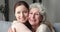 Excited young attractive woman cuddling happy older mature hoary mother.