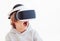 Excited young boy, kid wearing virtual reality goggles, playing videogames