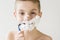 Excited Young Boy Shaving with Plastic Razor