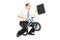 Excited young businessman with leather suitcase riding a small b