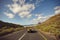 Excited young couple driving down on a open road