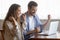 Excited young couple sitting by pc screen receiving profitable offer