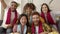 Excited young friends or multiracial football fans watching sports on TV