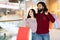 Excited young hindu couple enjoying season sale shopping together