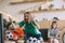 excited young man in green fan t-shirt throwing popcorn and celebrating while his upset friends sitting and gesturing behind on