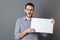 Excited young man holding a copy space banner