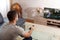 Excited young man watching basketball in living room