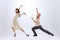 Excited young man and woman in retro style outfits dancing lindy hop isolated on white background. Timeless traditions