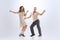 Excited young man and woman in retro style outfits dancing lindy hop  on white background. Timeless traditions