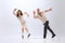 Excited young man and woman in retro style outfits dancing lindy hop  on white background. Timeless traditions