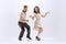 Excited young man and woman in retro style outfits dancing lindy hop  on white background. Timeless traditions