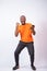 Excited young Nigerian man celebrates while looking at his phone isolated on a white background