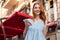 Excited young redhead girl holding mobile phone