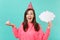 Excited young woman in birthday hat hold in hand cake with candle empty blank Say cloud speech bubble for promotional