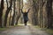 Excited young woman is jumping with arms raised up