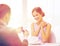 Excited young woman looking at boyfriend with ring