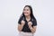 An excited young woman pumping both her fists, giddy with anticipation and energy. Isolated on a white backdrop