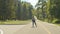 Excited young woman roller riding up and down hill