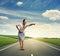 Excited young woman standing on the road