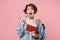 Excited young woman student in denim clothes backpack isolated on pastel pink background in studio. Education in high