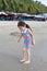 Exciting Asian child girl while come to play sand and sea at the beach on holiday