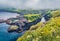 Exciting morning view of Gjogv village. Misty summer scene of Eysturoy island. Bright panoramic seascape of Atlantic ocean, Faroe