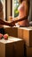 Exciting relocation: Close-up captures couple\\\'s hands clutching moving boxes in new residence.