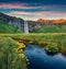 Exciting sunset on popular tourist destination - Seljalandsfoss waterfall