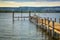 Exciting sunset at the shore with a wooden pier and sitting gulls