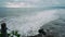 Exciting view of the coast of the island in the ocean during the tide of large waves