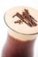 Exclusive coffee drink with cream foam and chocolate pieces, hot drink or cappuccino on white plate, product photography