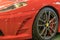 Exclusive sport car close up: car fender and bumper, headlight and wheel Red color