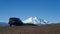 Excursion car on a mountain pass overlooking snow-capped Elbrus. Copy space.