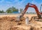 A Excuvator crawler digging a soil around foundation pile