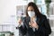 Executive wearing mask with asthma holding inhaler