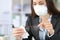 Executive wearing mask disinfecting glasses with sanitizer