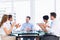 Executives clapping around conference table