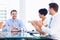 Executives clapping around conference table