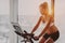 Exercise bike Asian woman training during pregnancy. Workout at home fitness gym watching online cycle class on